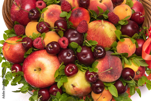 Basket with fresh fruits and berries close up