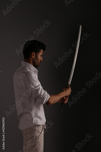 A man in white clothes with katana sword