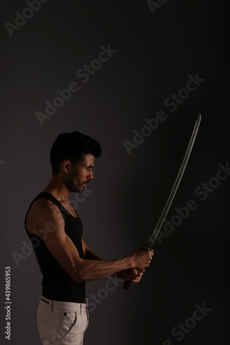 Fighter with katana sword in shadows