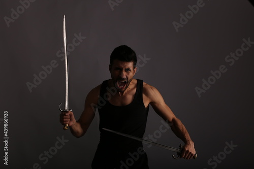 A fighter with two swords in shadows