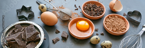 Mix of baking dessert ingredients on dark background, culinary flat lay