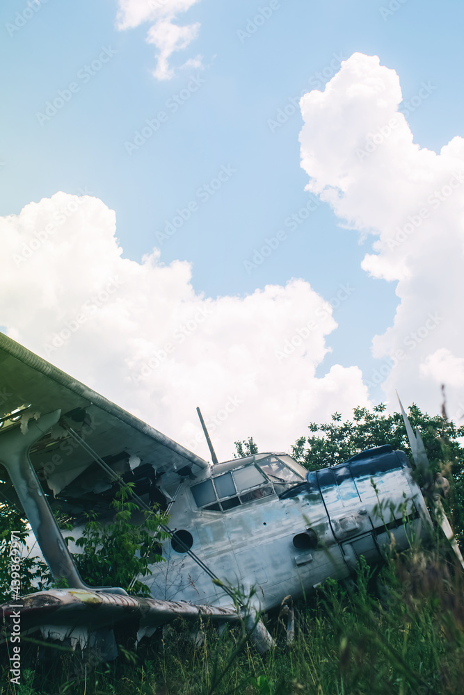 Close-up of a crashed airplane wing. The metal frame and internal parts are visible. Pieces of upholstery and fabric upholstery blow in the wind. Rust and debris Close-up of a crashed airplane wing. The metal frame and internal parts are visible. Pieces of upholstery and fabric upholstery blow in the wind. Rust and debris