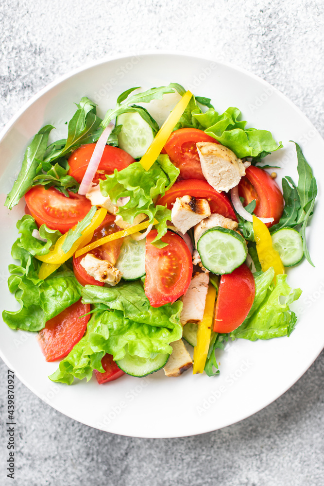 vegetable salad and chicken meat vegetables fresh tomato, cucumber, pepper organic dish on the table healthy food meal snack copy space food background rustic. top view