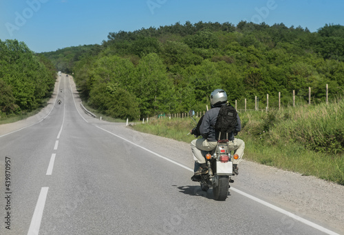 Two men are driving a motorcycle on country road © Yuri Bizgaimer