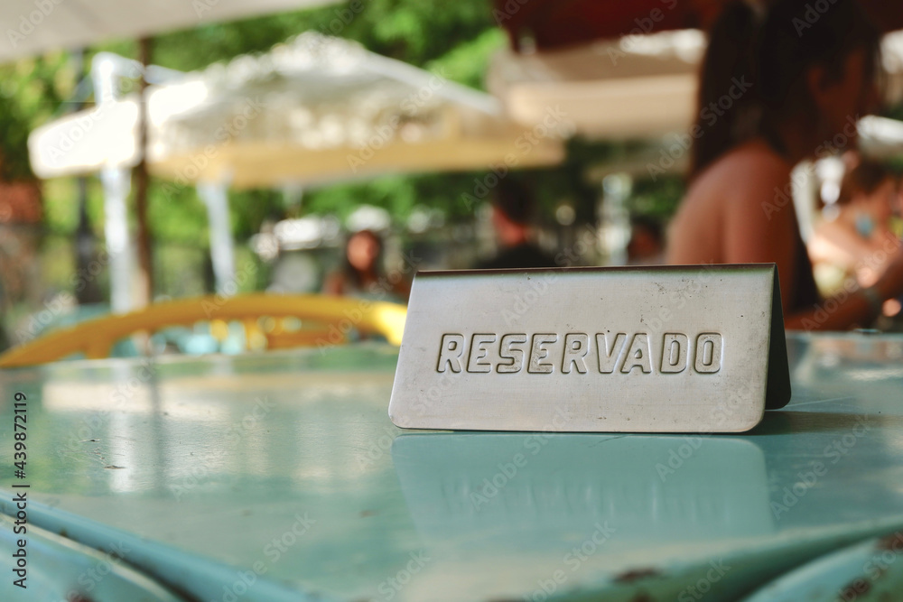 Reserved sign in Spanish language on empty table in outdoor terrace, Madrid,  Spain. Concept of restaurant business and hospitality sector recovery after  covid19 pandemic Stock Photo | Adobe Stock