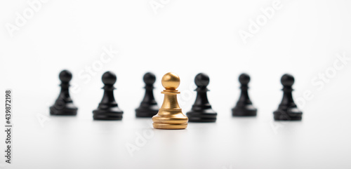 Golden Chess pawn standing in front of other chess  Concept of a leader must have courage and challenge in the competition  leadership and business vision for a win in business games