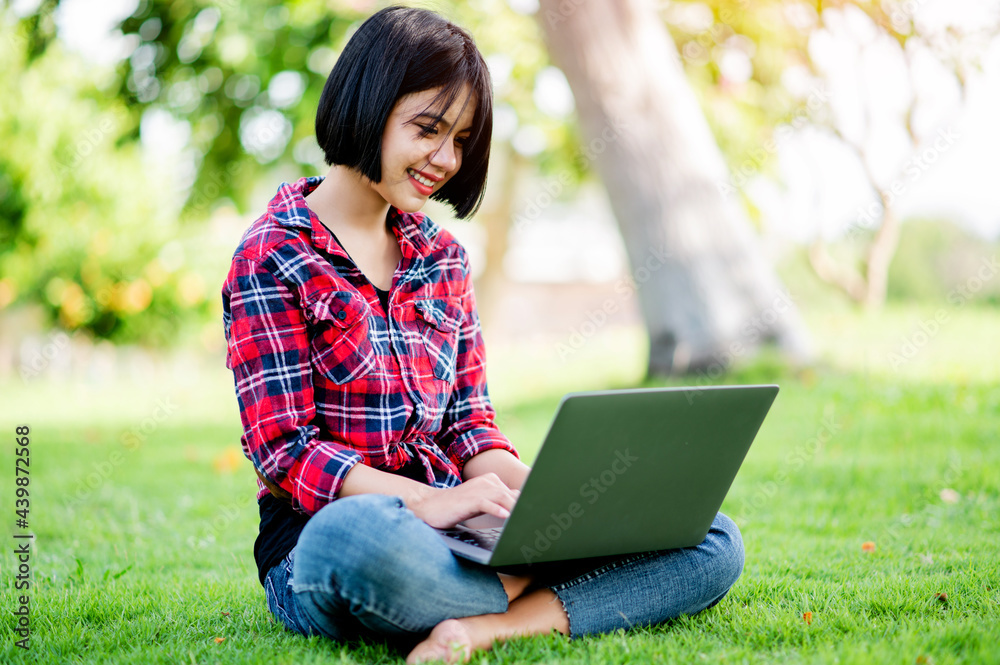 Asian women smile happily and laptop. Work online online communication Messaging Online learning Online communication concept Asian women smile happily and laptop. Work online online communication Messaging Online learning Online communication concept