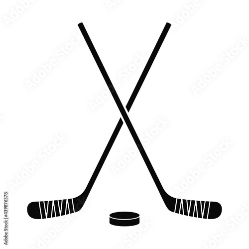 Ice hockey sticks and hockey puck as logo in vector icon photo