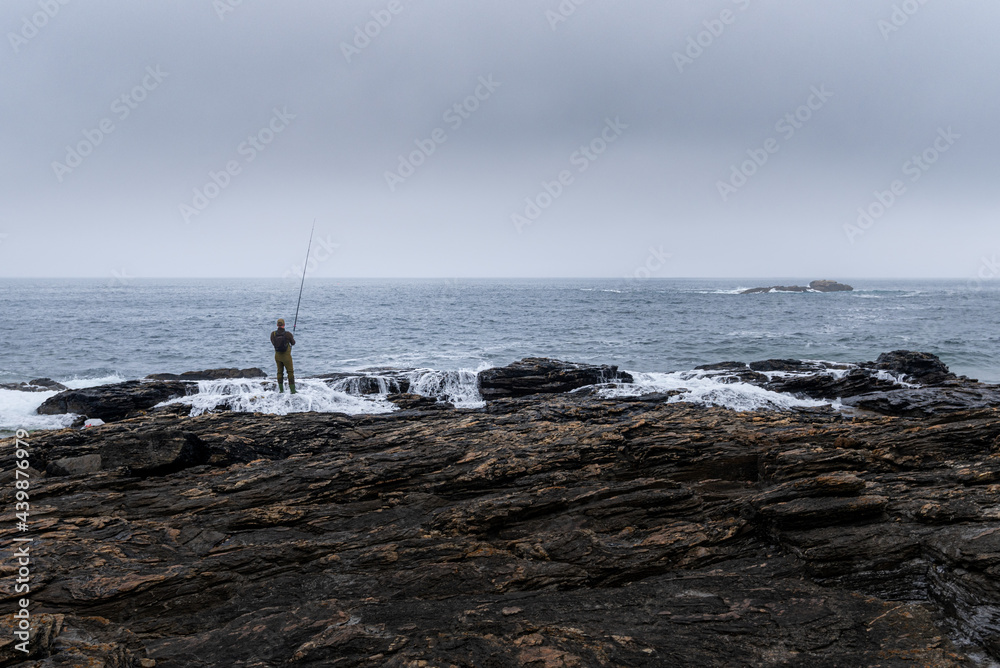 Fisherman trying to fish the dinner on the cliffs Fisherman trying to fish the dinner on the cliffs
