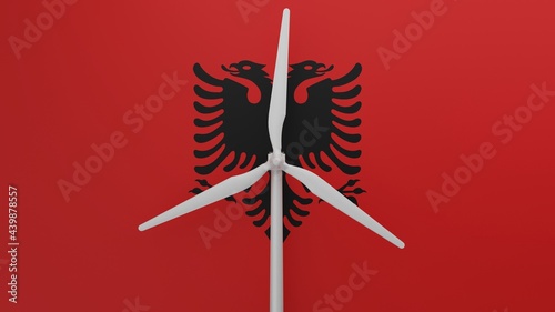 Large wind turbine in center with a background of the country flag of Albania