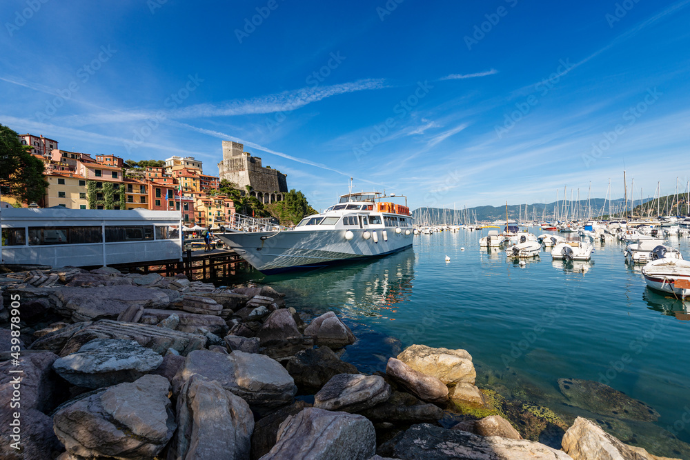 Fototapeta premium Port of Lerici town with many boats and the Ancient Castle (1152-1555). Tourist resort on the coast of the Mediterranean sea (Ligurian Sea), Gulf of La Spezia, Italy, Europe.
