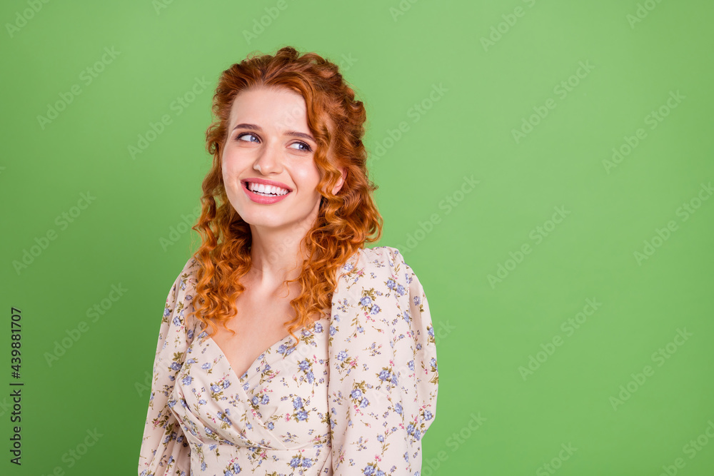 Obraz premium Photo of charming positive nice lady look empty space dream nice smile isolated on green color background