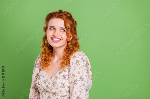 Photo of charming positive nice lady look empty space dream nice smile isolated on green color background