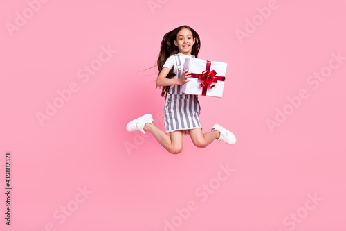 Full length photo charming happy attractive girl jump hold hands present isolated on pink color background