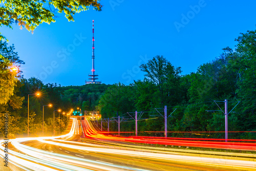 Germany, Stuttgart city skyline and urban cityscape of heavy traffic highway and radio tower on frauenkopf in magical night atmosphere photo