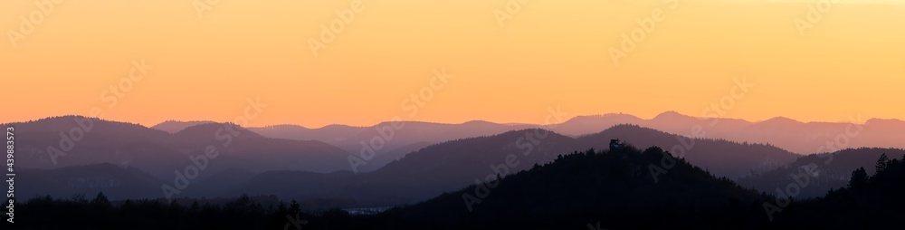 mountain layers after sunset during golden hour, orange sky, mountain silhouettes, sky during dusk