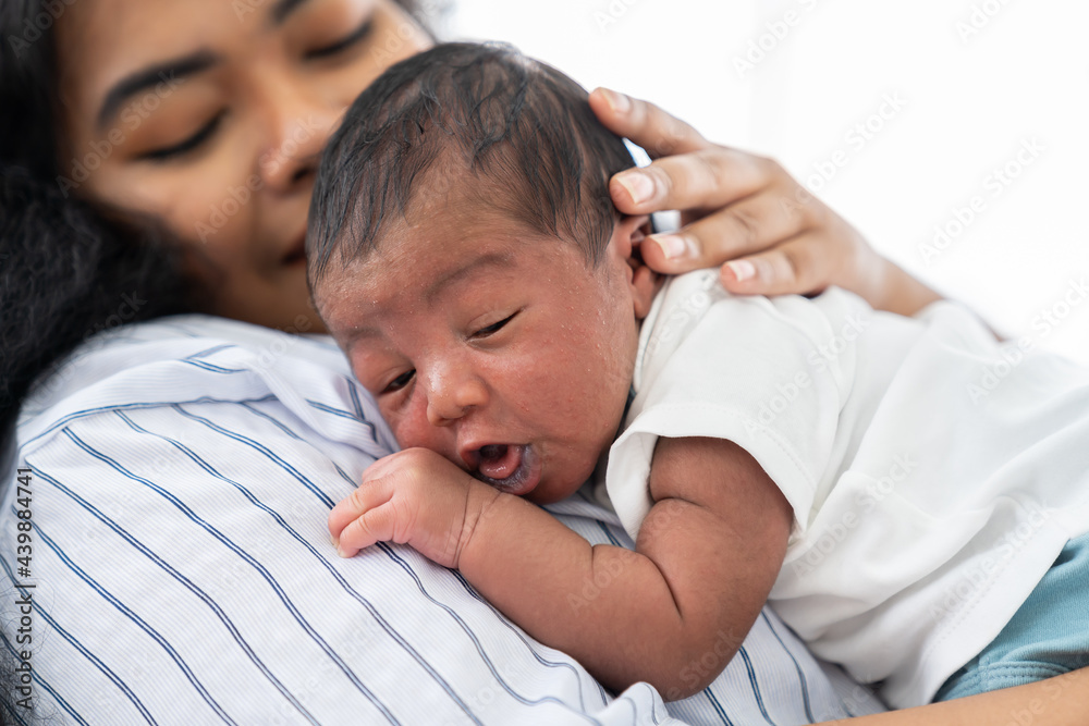 Close-up of African American newborn baby sleeping with mother. family, love, happy and new life concept Close-up of African American newborn baby sleeping with mother. family, love, happy and new life concept