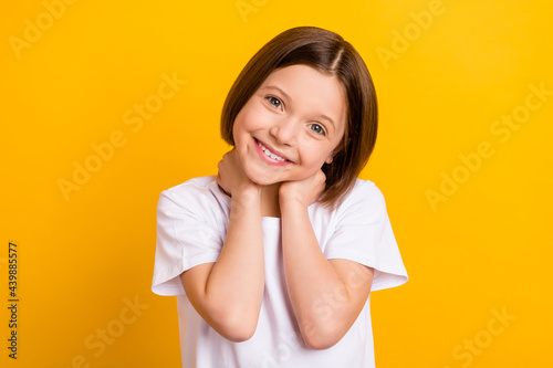 Photo portrait small schoolgirl smiling cheerful cute lovely isolated bright yellow color background