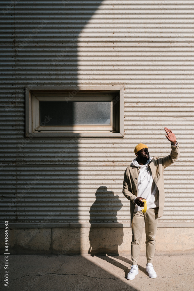 Black man covering his face to protect his face from the sun Black man covering his face to protect his face from the sun