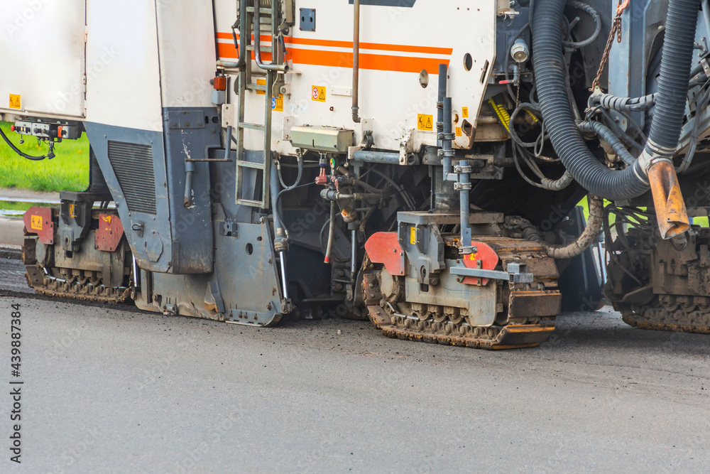 Support pillars of heavy industrial road machinery for repairing the road asphalt pavement.