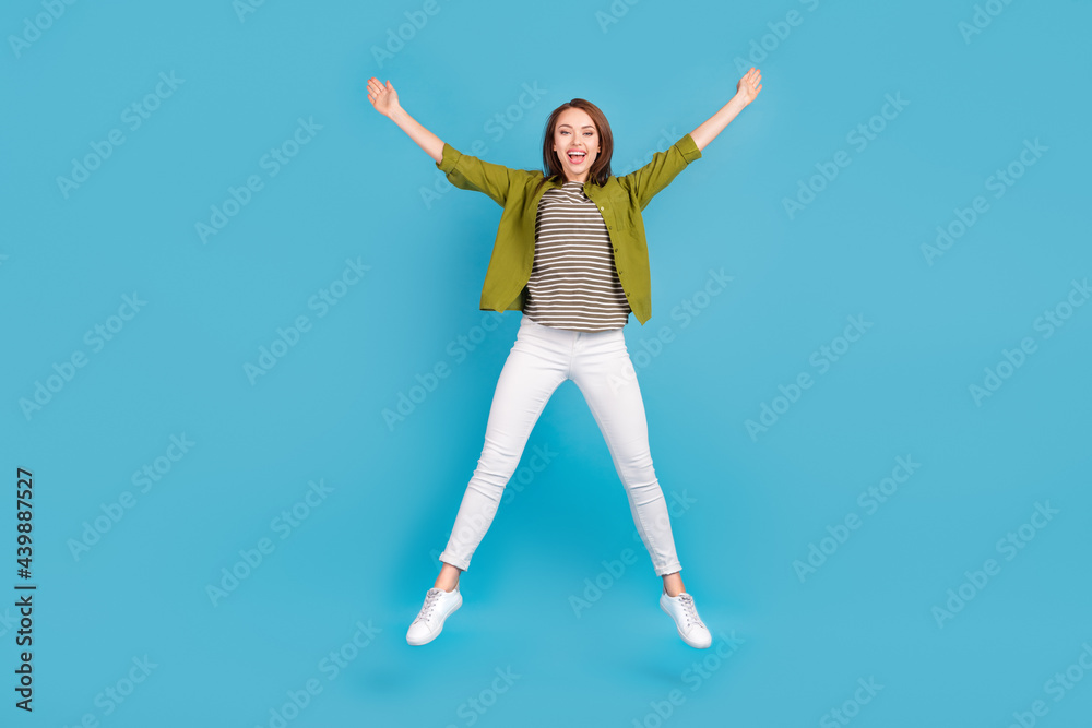 Full body photo of active happy pretty woman jump up star shape good mood isolated on blue color background