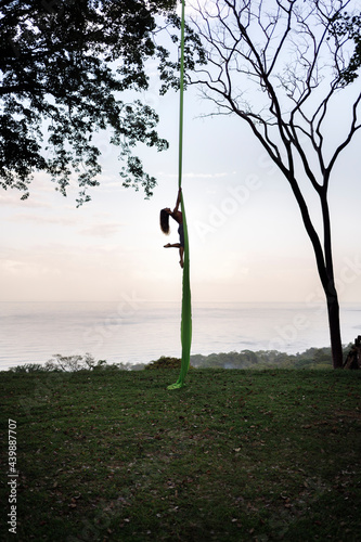 Silhouette of Woman in Aerial Yoga Swing photo