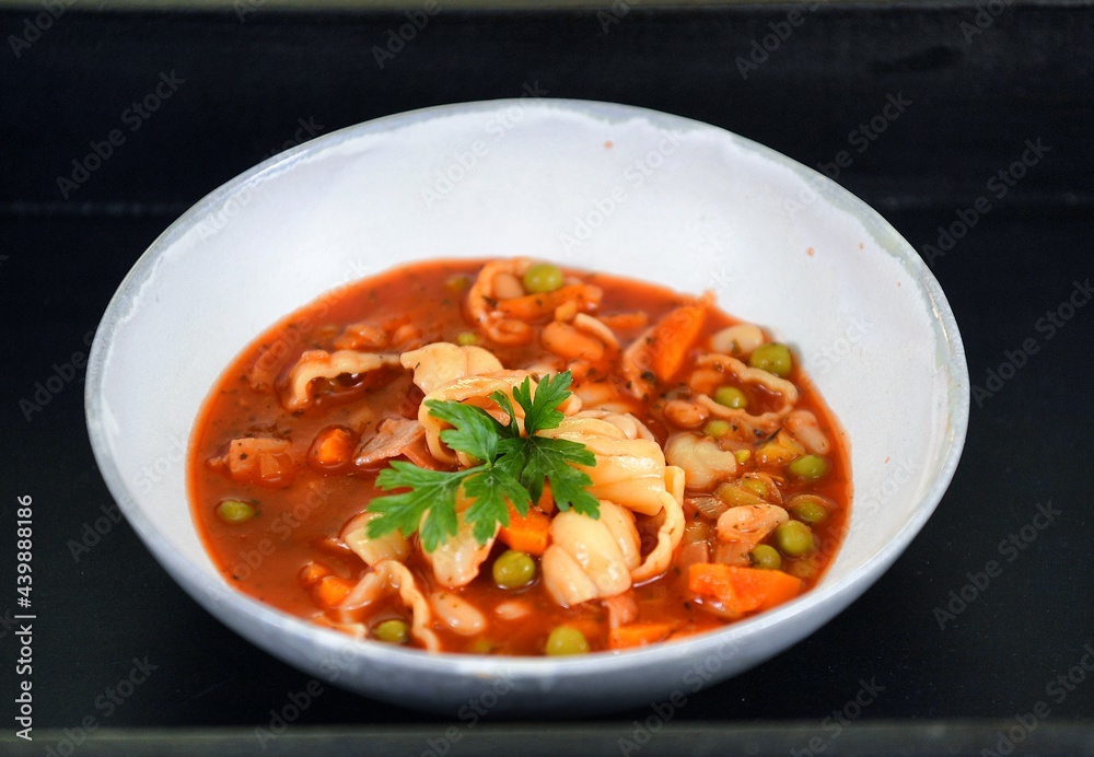 Vegetable soup on a plate on the wooden table Vegetable soup on a plate on the wooden table