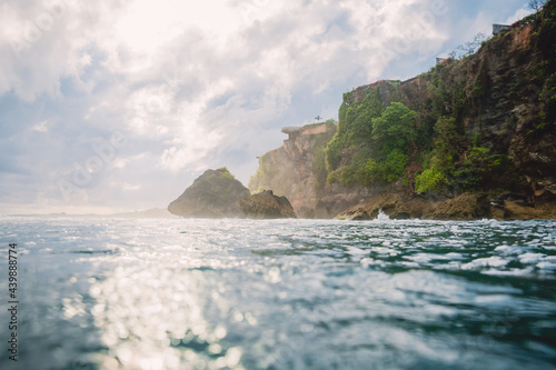 Ocean and cliff in Uluwatu with sunshine. Bali, Indonesia