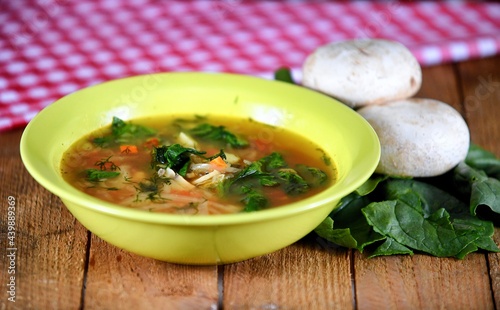 Vegetable soup on a plate on the wooden table photo