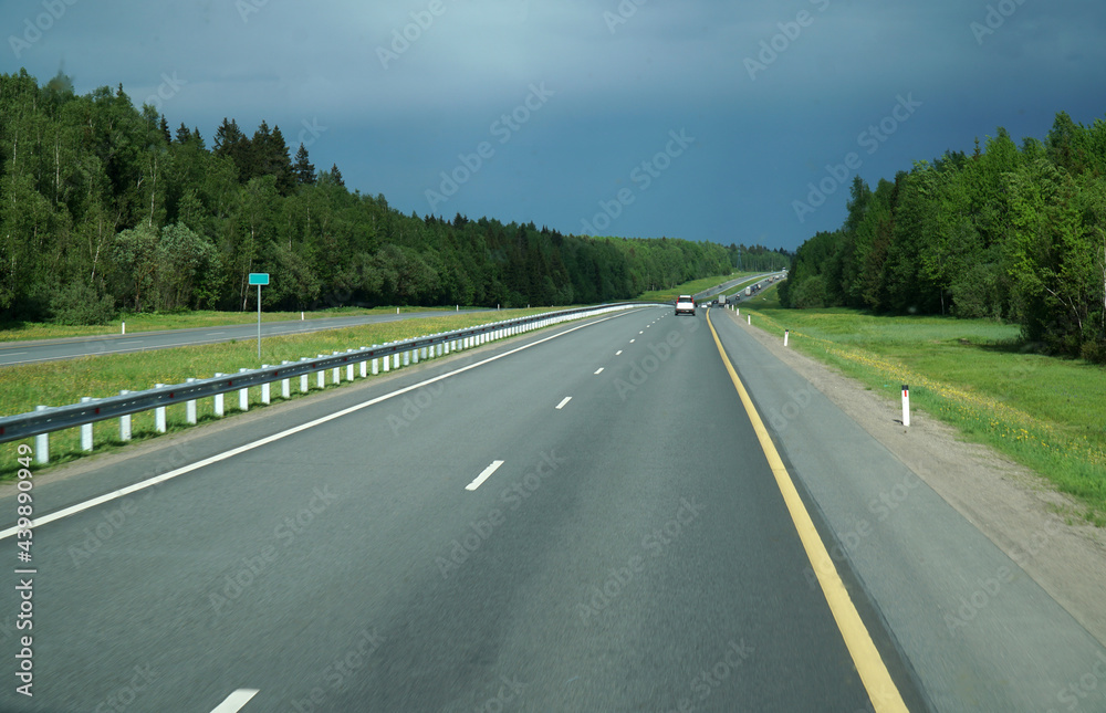 Fototapeta premium the highway stretching away into the distance summer trees
