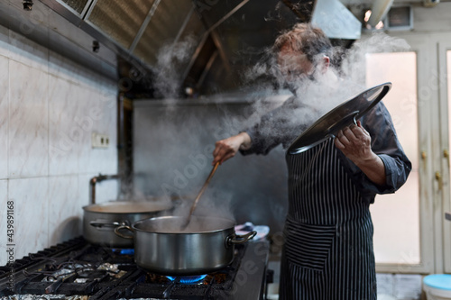Chef cook food at industrial kitchen