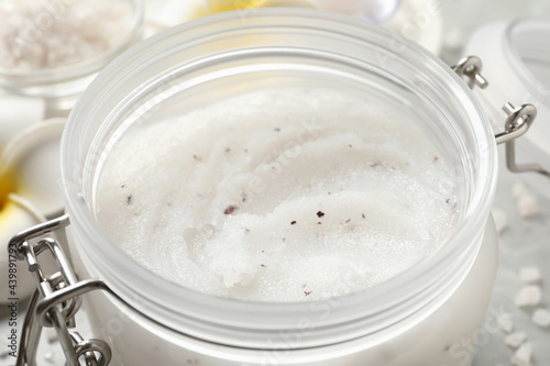 Body scrub in glass jar, closeup view