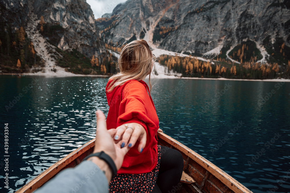Anonymous people on boat in dolomite lake Anonymous people on boat in dolomite lake