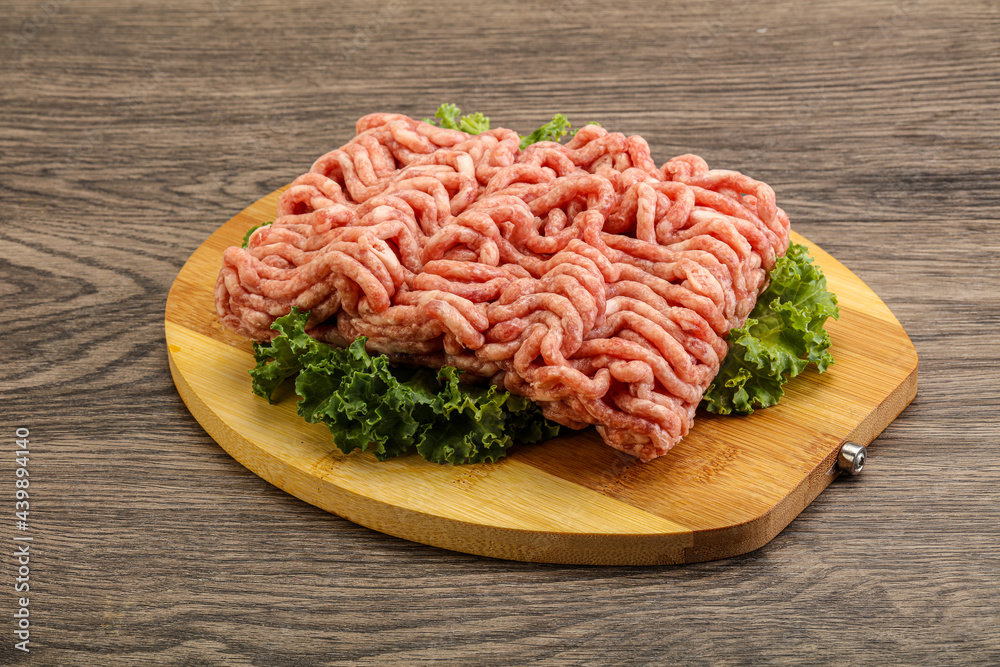 Raw pork minced meat over board Raw pork minced meat over board