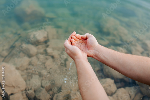 Anonymous person washing with river water