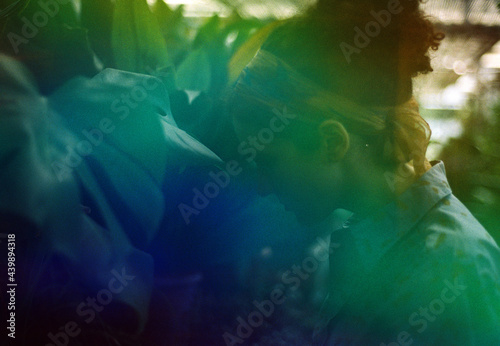 A woman in a greenhouse in a blue light