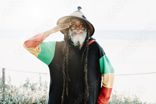Serene hippie rastaman standing on field