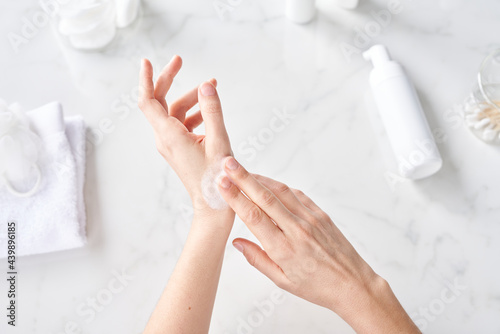 Woman rubbing foamy soap.
