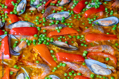 Spanish seafood paella in fry pan with mussels, shrimps and vegetables © OlegD