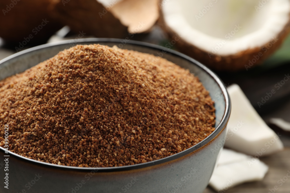 Natural coconut sugar in ceramic bowl on table, closeup Natural coconut sugar in ceramic bowl on table, closeup