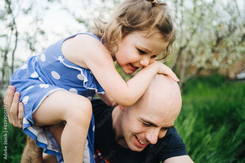 Father playing with daughter outdoors Father playing with daughter outdoors