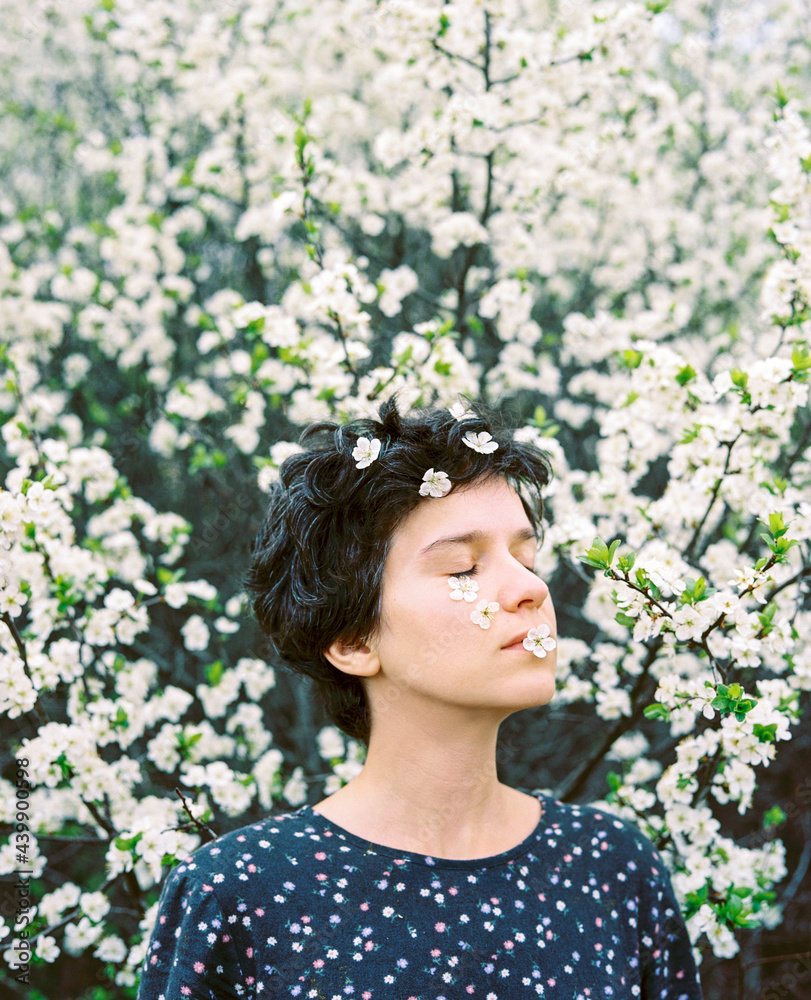Woman with short hair style enjoying bloom Woman with short hair style enjoying bloom