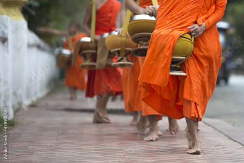 Buddhist monks on everyday morning traditional alms giving in Luang Prabang, Laos.