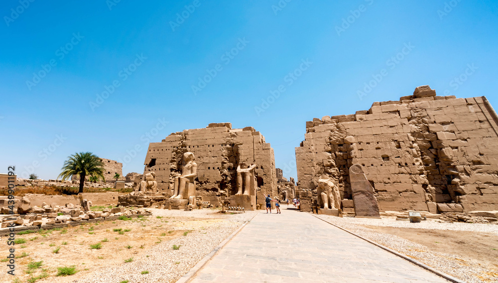 antique in the Karnak temple and tourists in luxury