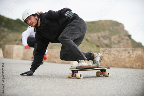 Downhill with longboard in the mountains. photo