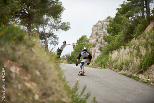 Downhill with longboard in the mountains. photo