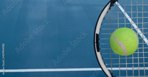 Composition of tennis ball and racket with copy space on tennis court © vectorfusionart