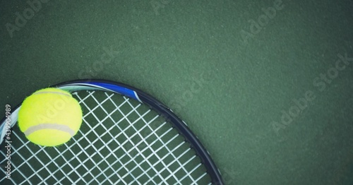 Composition of tennis ball and racket with copy space on tennis court © vectorfusionart