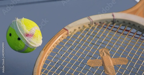 Composition of tennis ball and racket with plaster on tennis court