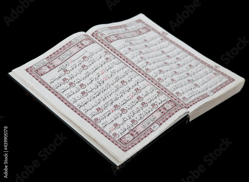 Muslim religious book isolated image on black background.